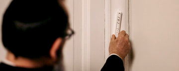 Rabbi affixing a Mezuzah