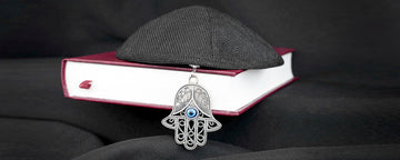 Hamsa and a Yamaka on a Bible