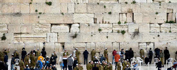 Men praying at the Western Wall also known as Kotel in Jerusalem